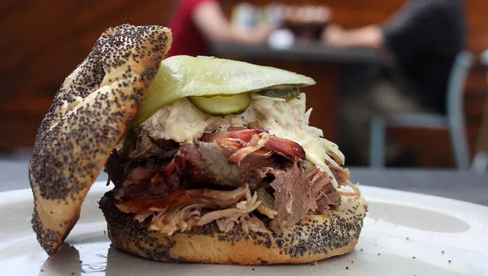 Slows Bar BQ signature dishes The Reason (Pulled Pork Sandwich), The Longhorn (Beef Brisket Sandwich), The Yardbird (Pulled Chicken Sandwich), Baby Back Ribs, Mac & Cheese.